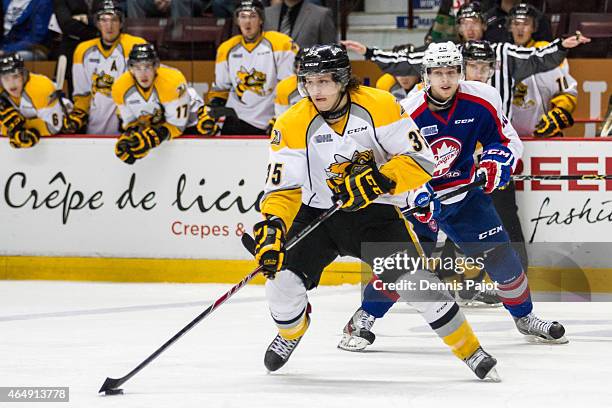 Forward Nikita Korostelev of the Sarnia Sting moves the puck against the Windsor Spitfires on March 1, 2015 at the WFCU Centre in Windsor, Ontario,...