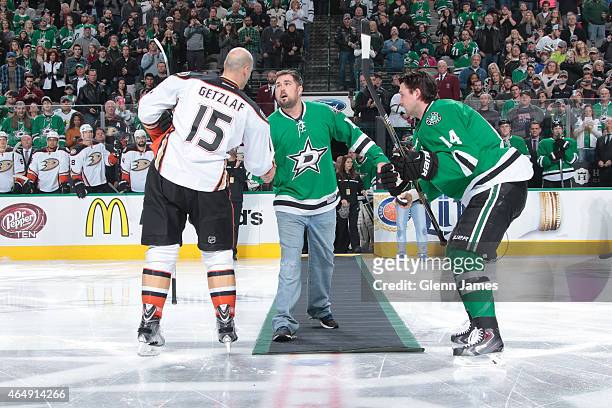 Former U.S. Navy Seal Marcus Luttrell drops the ceremonial first puck as part of Military Appreciation night between Ryan Getzlaf of the Anaheim...