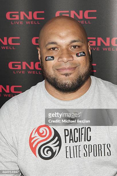 Former Baltimore Ravens player Maake Kemoeatu signs autographs at the Pacific Elite Sports Fitness Center Grand Opening on January 24, 2014 in...