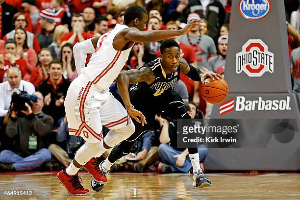 Jon Octeus of the Purdue Boilermakers drives the ball upcourt against the defense of Shannon Scott of the Ohio State Buckeyes during the first half...