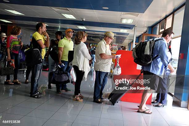 Miami-bound passengers have their tickets checked as they prepare to board a charter plane at José Martí International Airport on March 1, 2015 in...