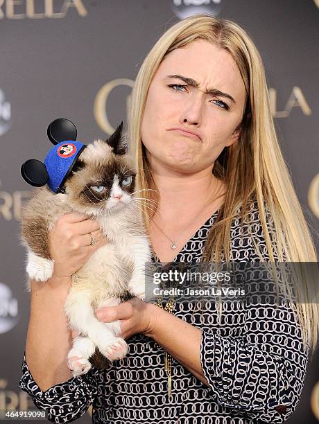 Grumpy Cat and Tabatha Bundesen attend the premiere of "Cinderella" at the El Capitan Theatre on March 1, 2015 in Hollywood, California.
