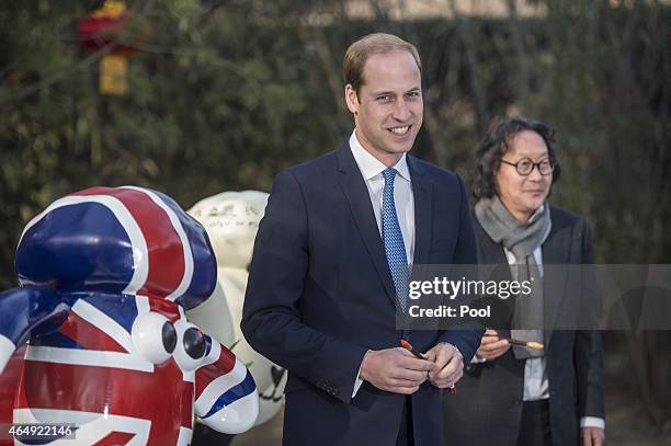 Prince William, Duke of Cambridge poses after painting the eye of "shaun the sheep" at the British Ambassador's official residence on March 2, 2015...
