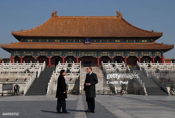 Prince William, Duke of Cambridge talks to a Chinese museum officer during a visit to the Forbidden City on March 2, 2015 in Beijing, China. The Duke...