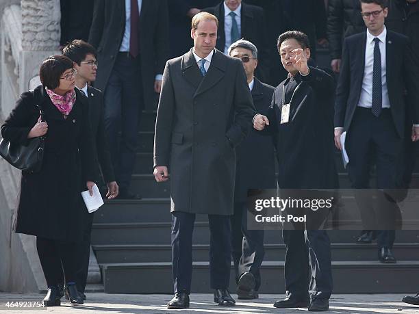 Prince William, Duke of Cambridge is accompanied by a museum officer during a visit to the Forbidden City on March 2, 2015 in Beijing, China. The...