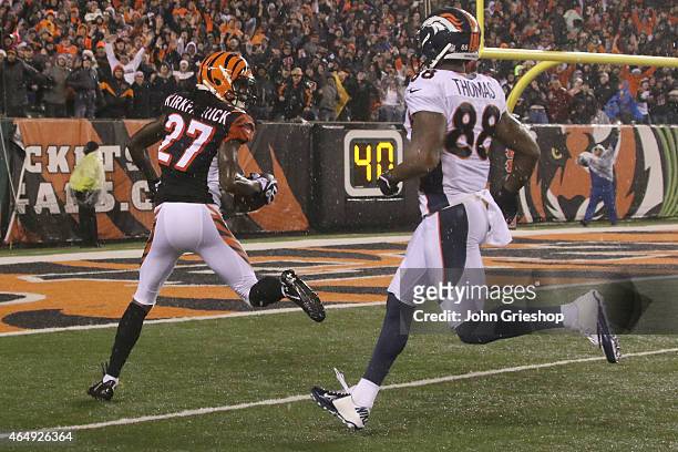 Dre Kirkpatrick of the Cincinnati Bengals returns the football against Demaryius Thomas of the Denver Broncos during their game at Paul Brown Stadium...