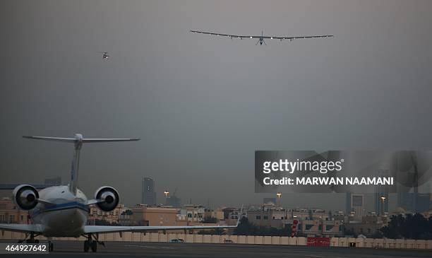 Bertrand Piccard, one of the two Swiss pilots of the solar-powered plane Solar Impulse 2, lands at the Emirati capital Abu Dhabi's small Al-Bateen...