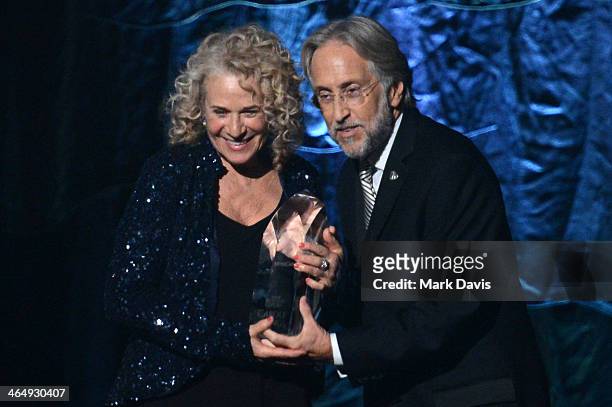 Honoree Carole King accepts MusiCares Person Of The Year award from CEO/President of the National Academy of Recording Arts & Sciences Neil Portnow...