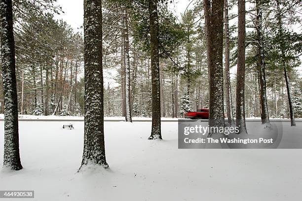 Vehicle travels along HWY 45, south of Watersmeet, MI on December 20, 2014. The rural landscape is home to the nearby Lac Vieux Desert tribe...