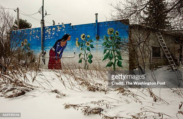 Painting by Ed Wuytack of a local tribal woman adorns the side of his welding shop in Watersmeet, MI on December 21, 2014. Wuytack said he painted it...