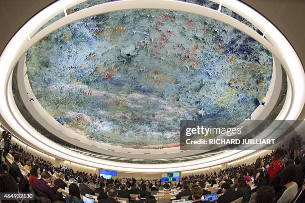 Delegates are seen beneath a ceiling painted by Spanish artist Miquel Barcelo during 28th Human Rights Council at the United Nations headquarters in...