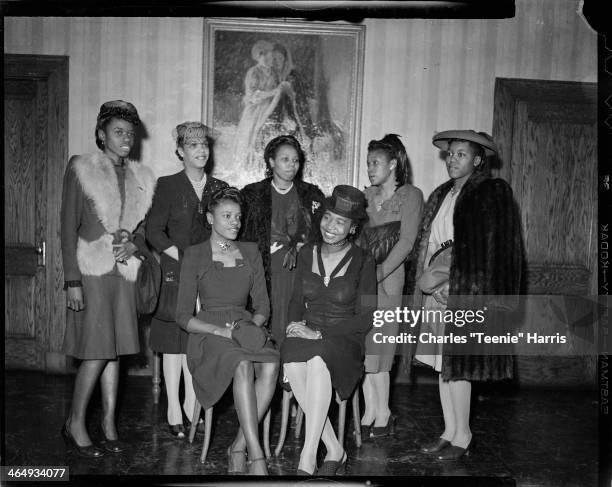 Group portrait of beauty shop owners, posed in Centre Avenue YMCA with Henry O Tanner painting 'Christ and His Mother,' Pittsburgh, Pennsylvania,...