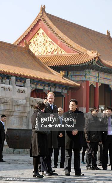 Prince William, Duke of Cambridge with Mr Zhang Yaoguang the Vice-Director of Foreign Affairs at the Forbidden City and his interpreter as they tour...