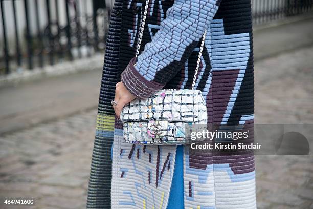 Stylist and fashion blogger Diana Gavrilina wears a Peter Pilotto coat, Roksanda Illinic dress, Chanel bag on February 24, 2015 in London, England.