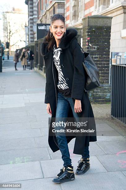 Model Hadassa Lima wears a Forecaster coat, vintage top, Unique jeans, Michael shoes and Zara bag on February 24, 2015 in London, England.
