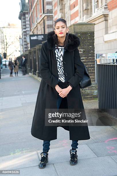 Model Hadassa Lima wears a Forecaster coat, vintage top, Unique jeans, Michael shoes and Zara bag on February 24, 2015 in London, England.