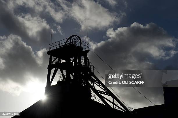 The sun shines behind the headframe of a shaft mine at the National Coal Mining Museum based on the site of the former Caphouse Colliery in Overton,...