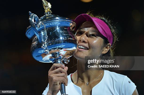 China's Li Na poses with the trophy after her victory against Slovakia's Dominika Cibulkova during the women's singles final on day 13 of the 2014...