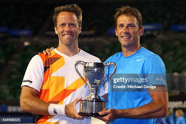 Lukasz Kubot of Poland and Robert Lindstedt of Sweden pose with the winners trophy after winning their Men's Doubles Final against Eric Butorac of...