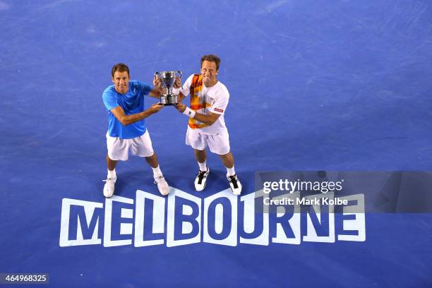Lukasz Kubot of Poland and Robert Lindstedt of Sweden pose with the winners trophy after winning their Men's Doubles Final against Eric Butorac of...