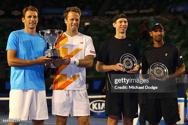 Lukasz Kubot of Poland and Robert Lindstedt of Sweden pose with the winners trophy, and Eric Butorac of the United States and Raven Klaasen of South...