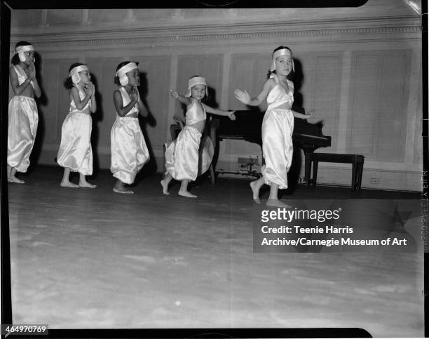 Betty Love, Lendia O Jackson, Relda K Tames, Patricia L Chavis, and Mary Eaton wearing halter top and harem pant dance costumes, performing for...