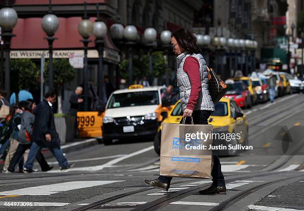 Pedestrian carries a Ross Dress For Less shopping bag on March 2, 2015 in San Francisco, California. According to a Commerce Department report,...