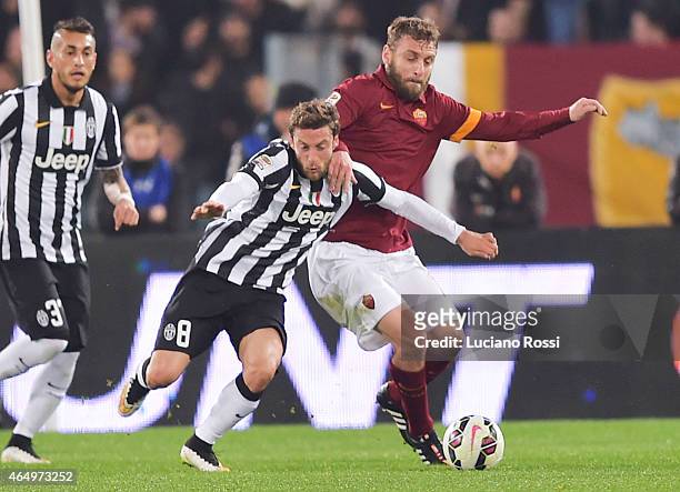 Roma player Daniele De Rossi is challenged by FC Juventus player Claudio Marchisio during the Serie A match between AS Roma and Juventus FC at Stadio...