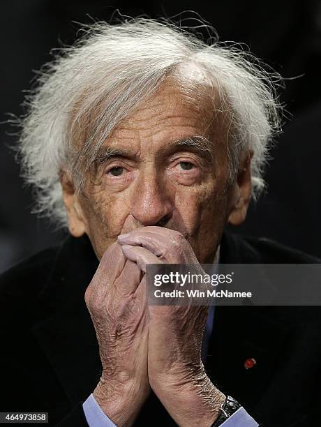 Nobel Peace Laureate Elie Wiesel warms his hands after arriving for a roundtable discussion on Capitol Hill March 2, 2015 in Washington, DC. Wiesel,...
