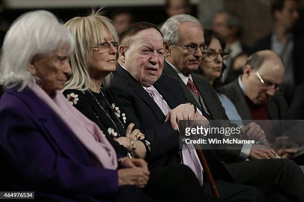 Marion Wiesel, Miriam Adelson, and American businessman Sheldon Adelson listen to speakers during a roundtable discussion on Capitol Hill March 2,...