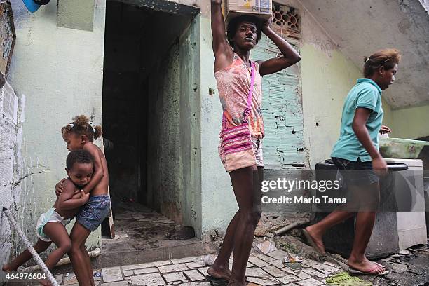 People gather in the Complexo da Mare 'favela' complex, one of the largest 'favela' complexes in Rio, on March 2, 2015 in Rio de Janeiro, Brazil. The...