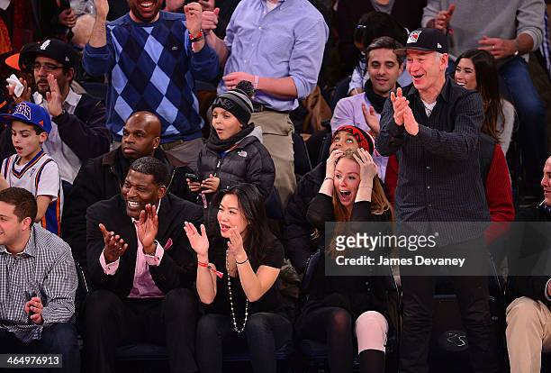 Larry Johnson, guest, Anna McEnroe and John McEnroe attend the Charlotte Bobcats vs New York Knicks game at Madison Square Garden on January 24, 2014...