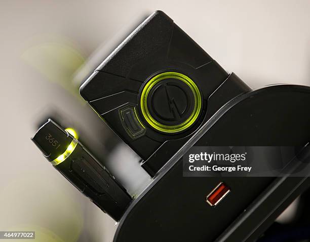 Several newly-deployed body cameras and batteries sit in the patrol room charging and downloading video at the West Valley City Police Department on...