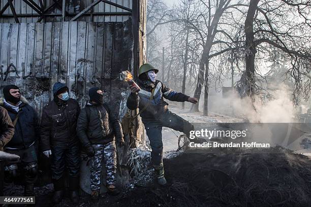 An anti-government protester throws a Molotov cocktail during clashes with police on Hrushevskoho Street near Dynamo stadium on January 25, 2014 in...