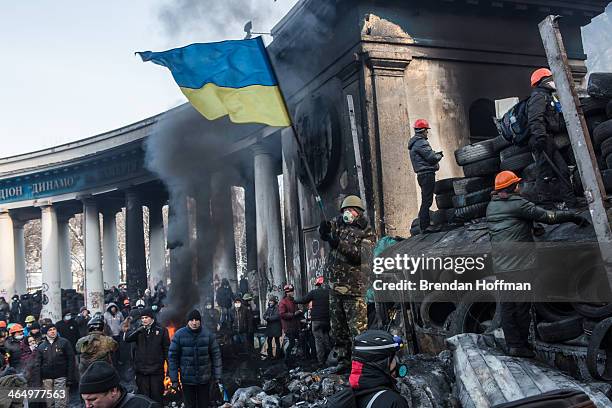 An anti-government protester waves a Ukrainian flag during clashes with police on Hrushevskoho Street near Dynamo stadium on January 25, 2014 in...