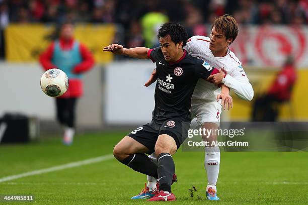 Shinji Okazaki of Mainz is challenged by Gotoku Sakai of Stuttgart during the Bundesliga match between VfB Stuttgart and 1. FSV Mainz 05 at...