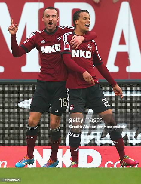 Timothy Chandler of Nuernberg celebrates scoring the opening goal with his team mate Josip Drmic during the Bundesliga match between 1. FC Nuernberg...