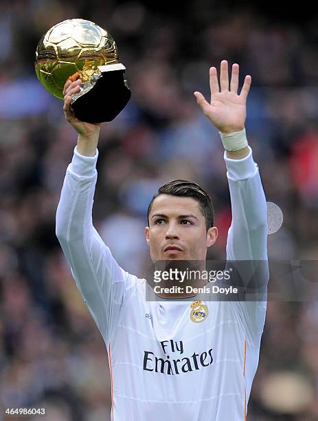 Cristiano Ronaldo of Real Madrid CF holds up the Ballon d'Or 2013 award prior to he start of the La Liga match between Real Madrid CF and Granada CF...