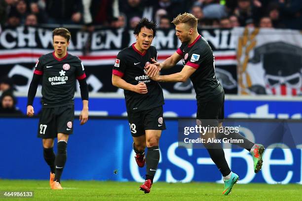 Shinji Okazaki of Mainz celebrates his team's first goal with team mates Nicolai Mueller and Johannes Geis during the Bundesliga match between VfB...
