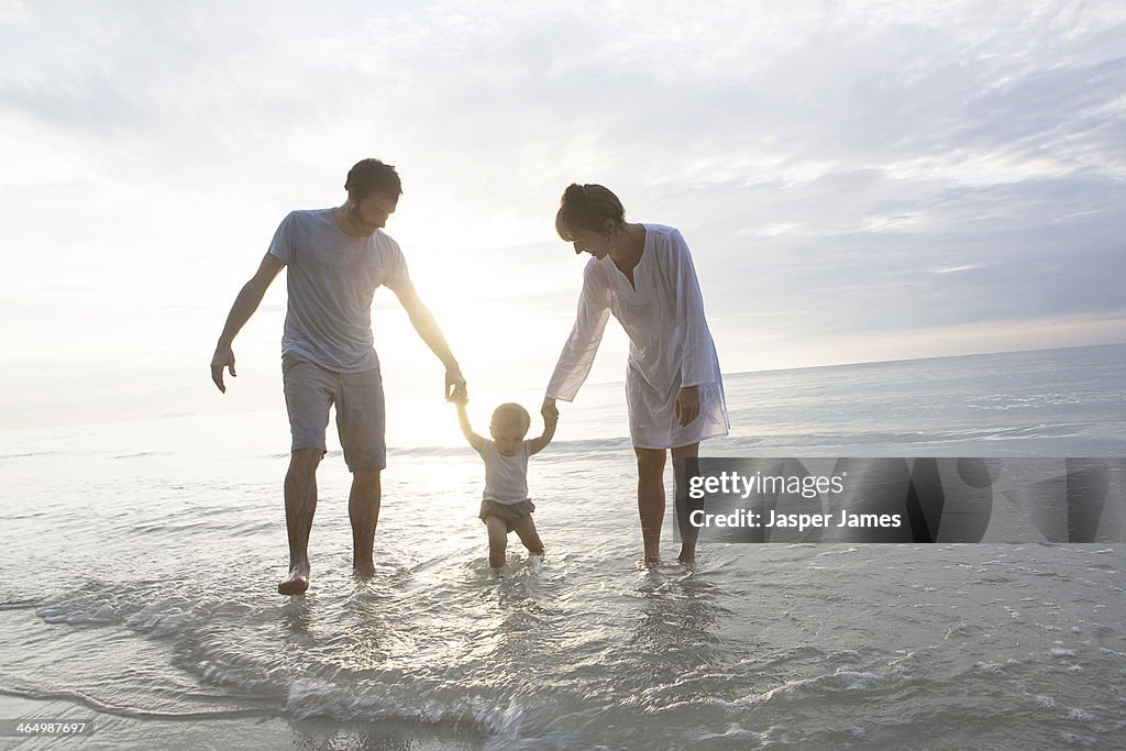 Family walking in the sea in thailand