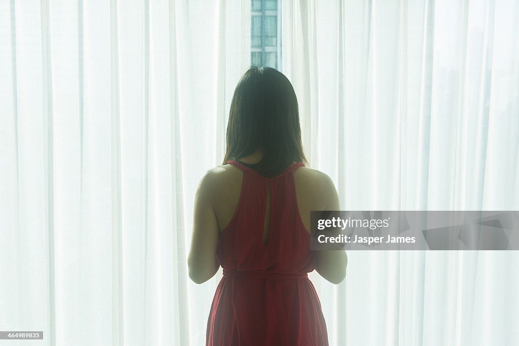 Woman looking out of a window