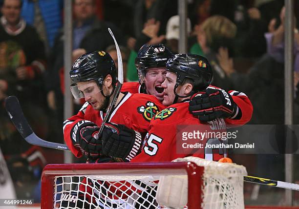 Marcus Kruger, Joakim Nordstrom and Andrew Shaw of the Chicago Blackhawks celebrate Kruger's second period goal against the Carolina Hurricanes at...