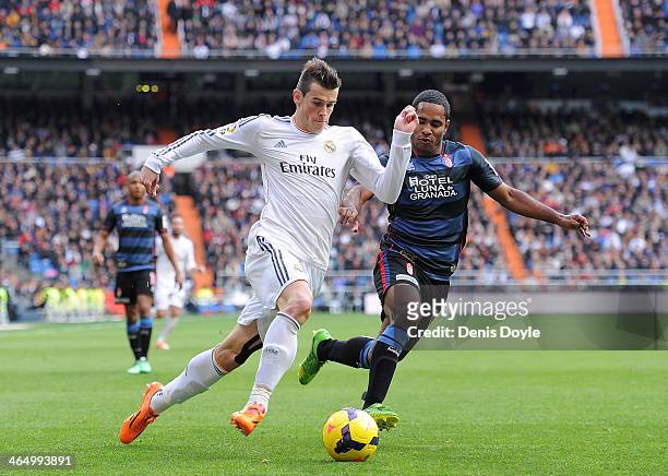 Gareth Bale of Real Madrid CF tries to outrun Brayan Angulo of Granada CF during the La Liga match between Real Madrid CF and Granada CF at Santiago...