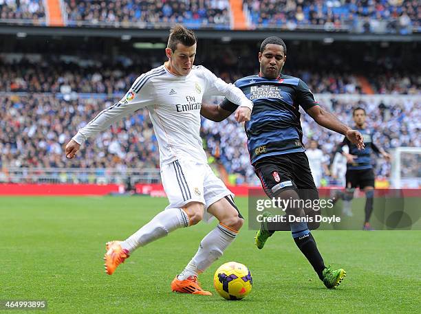 Gareth Bale of Real Madrid CF tries to outrun Brayan Angulo of Granada CF during the La Liga match between Real Madrid CF and Granada CF at Santiago...