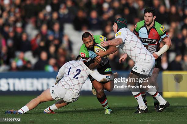 Jordan Turner-Hall of Harlequins is tackled by Terrence Hepetema of Leicester Tigers during the LV= Cup match between Harlequins and Leicester Tigers...