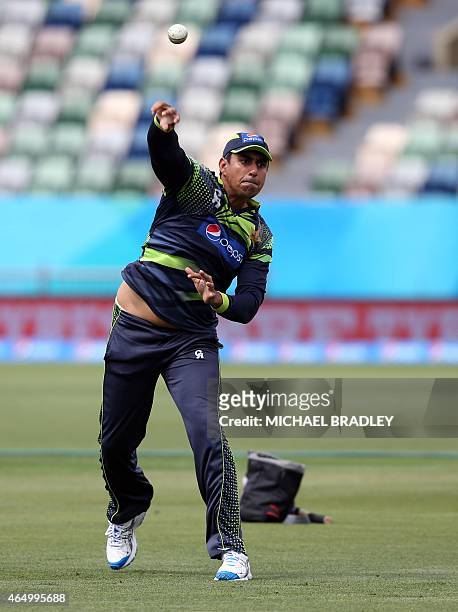 Pakistan's Nasir Jamshed throws the ball during a training session ahead of their 2015 Cricket World Cup Group B match against United Arab Emirates...