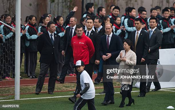 Britain's Prince William walks during his visit to a Premier League football training camp in Shanghai on March 3, 2015. The Duke of Cambridge is in...