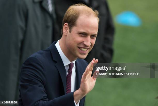 Britain's Prince William waves to students during his visit to a Premier League football training camp in Shanghai on March 3, 2015. The Duke of...