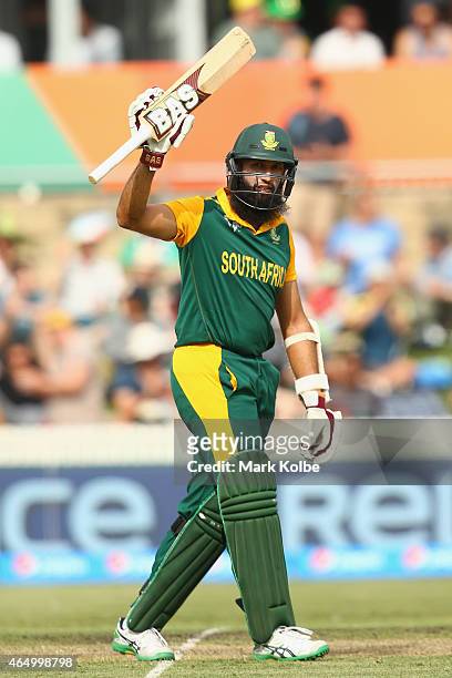 Hashim Amla of South Africa celebrates his century during the 2015 ICC Cricket World Cup match between South Africa and Ireland at Manuka Oval on...
