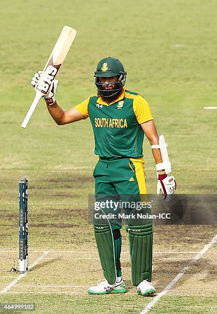 Hasim Amla of South Africa celebrates scoring a century during the 2015 ICC Cricket World Cup match between South Africa and Ireland at Manuka Oval...